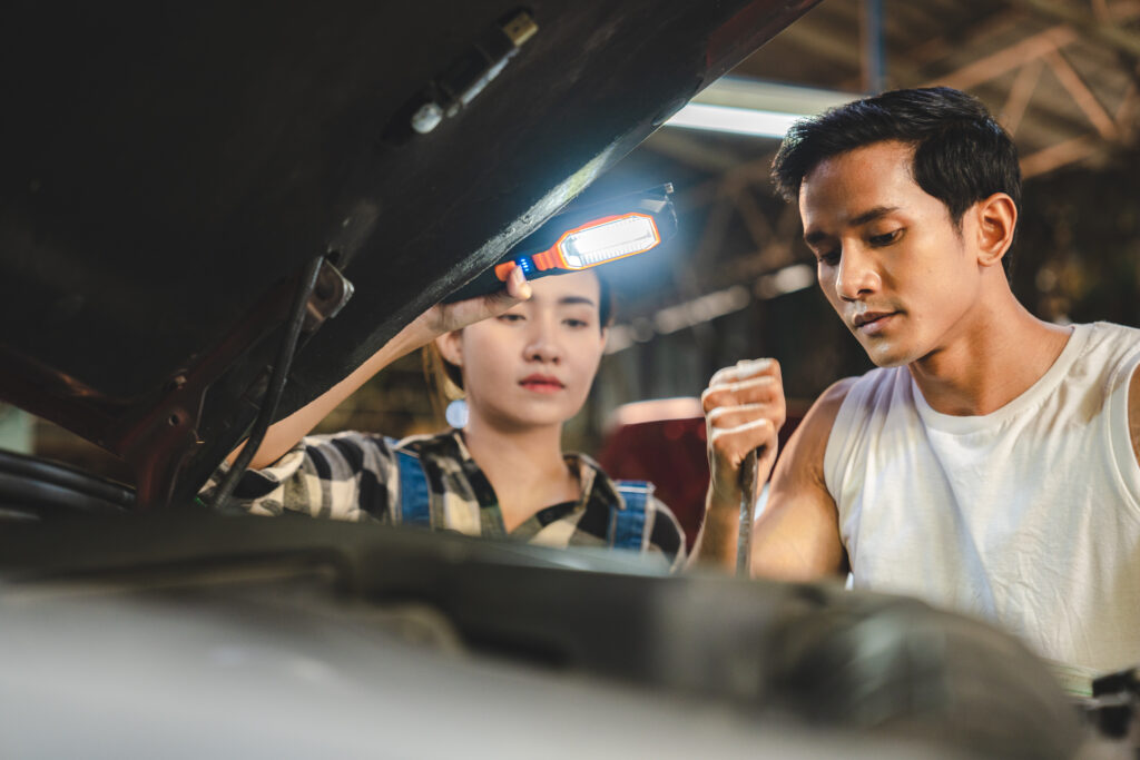 Professional mechanic technician working on the car engine in garage. auto repair service concept, maintenance inspection job to checking vehicle automobile at transport station