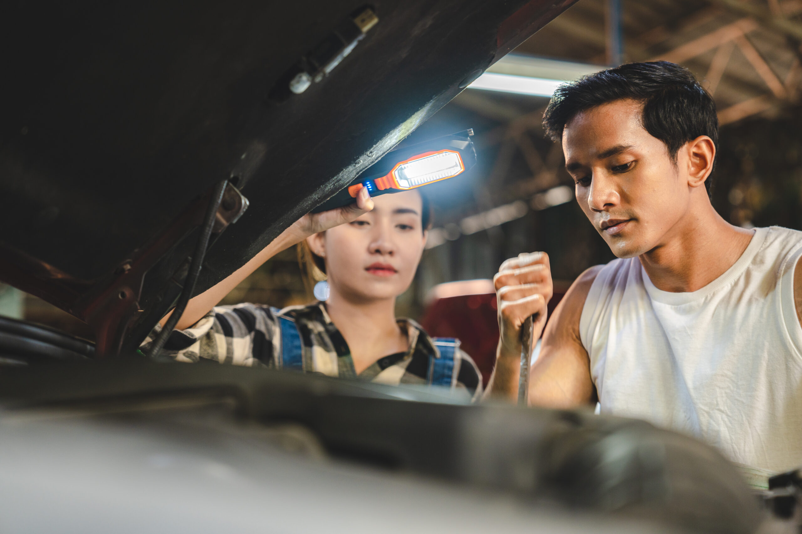 Professional mechanic technician working on the car engine in garage. auto repair service concept, maintenance inspection job to checking vehicle automobile at transport station